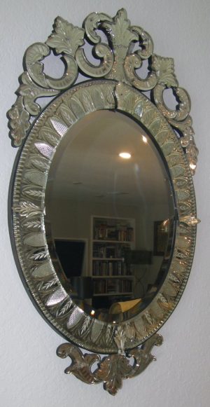 3148::  Mirror, wall-hung, ca.1920, Italian, oval vertical mirror housed in an entirely mirrored glass frame in the ornate manner of Murano Island artisans featuring a broad openwork apex crest repeated at the inferior aspect to a lesser extent, embellished overall with ornate etching. Dimensions:  42½”height,  24¼”width